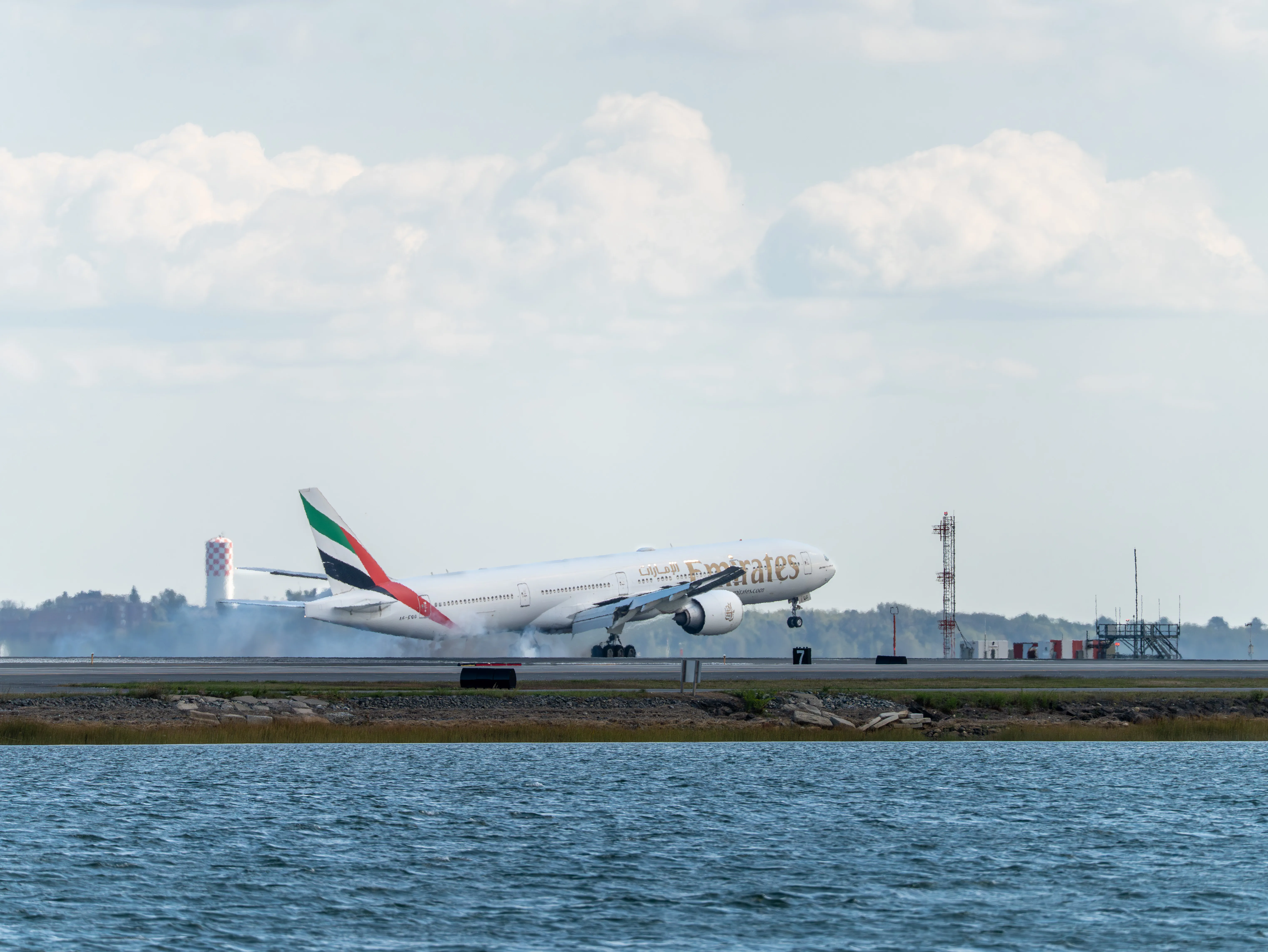 Emirates Boeing B777-31HER (registration number A6-EQG) touching the runway 22L