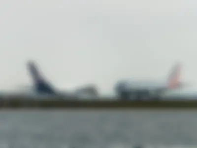 Lufthansa Airbus A380-841 (registration number D-AIMB) and American Airlines Airbus A319-132 (registration number N826AW) appear to be the same size due to perspective, as the closer A319 makes the farther A380 look smaller