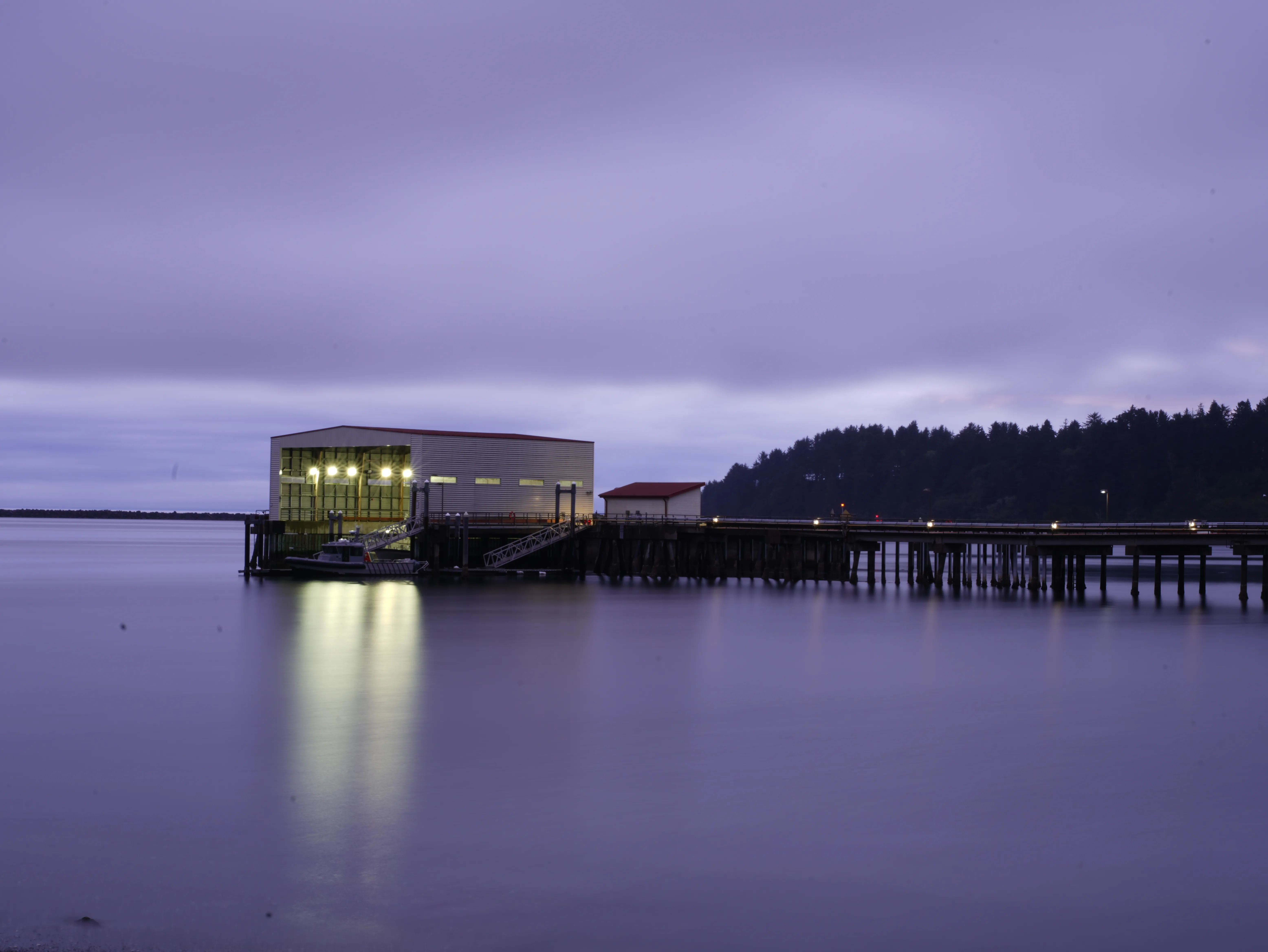 Ocean in purple and blue with a building