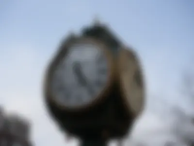 A four-faced roadside clock bearing the Boston University mark