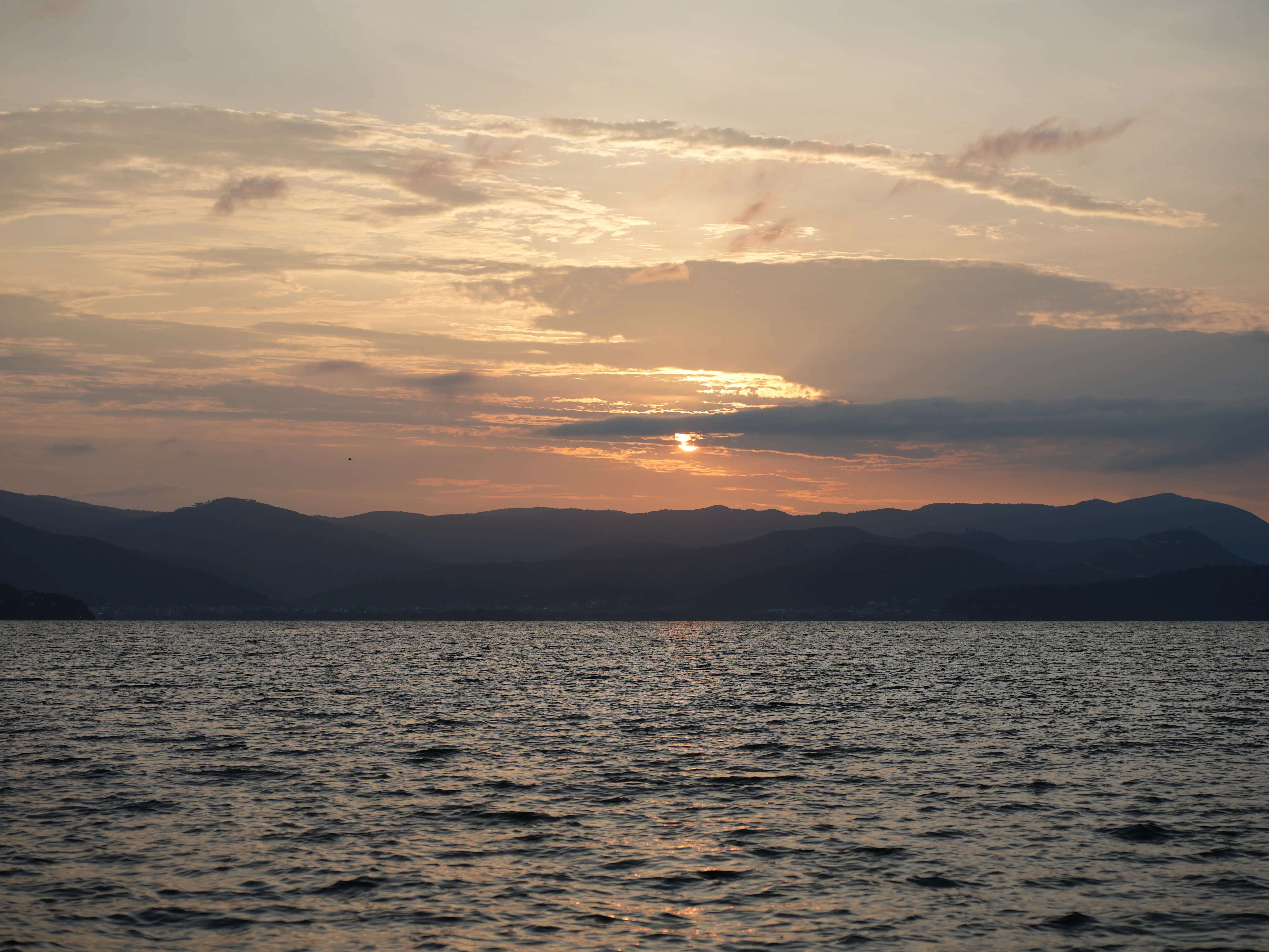 Peaceful sunrise from mountains over Erhai Lake