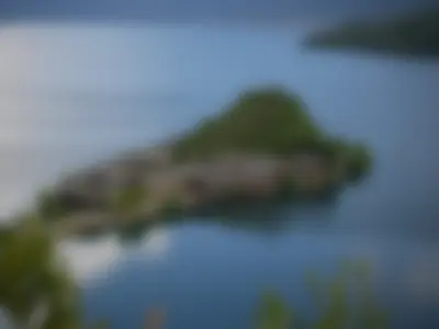 An Island on Lugu Lake with traditional Chinese architecture on it, forming a illusion of a lilliputian village