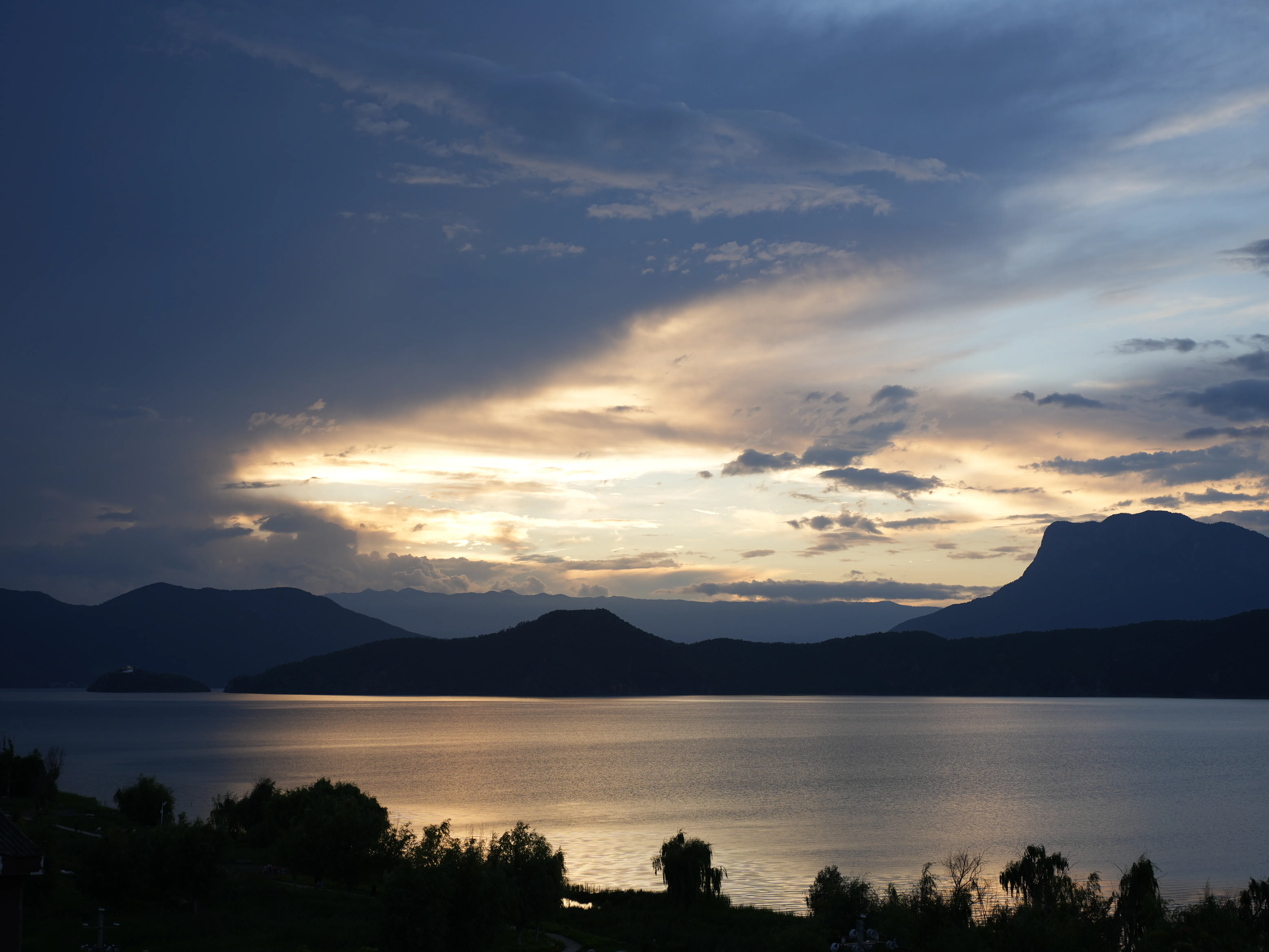 Sunset glow of Lugu Lake and mountains