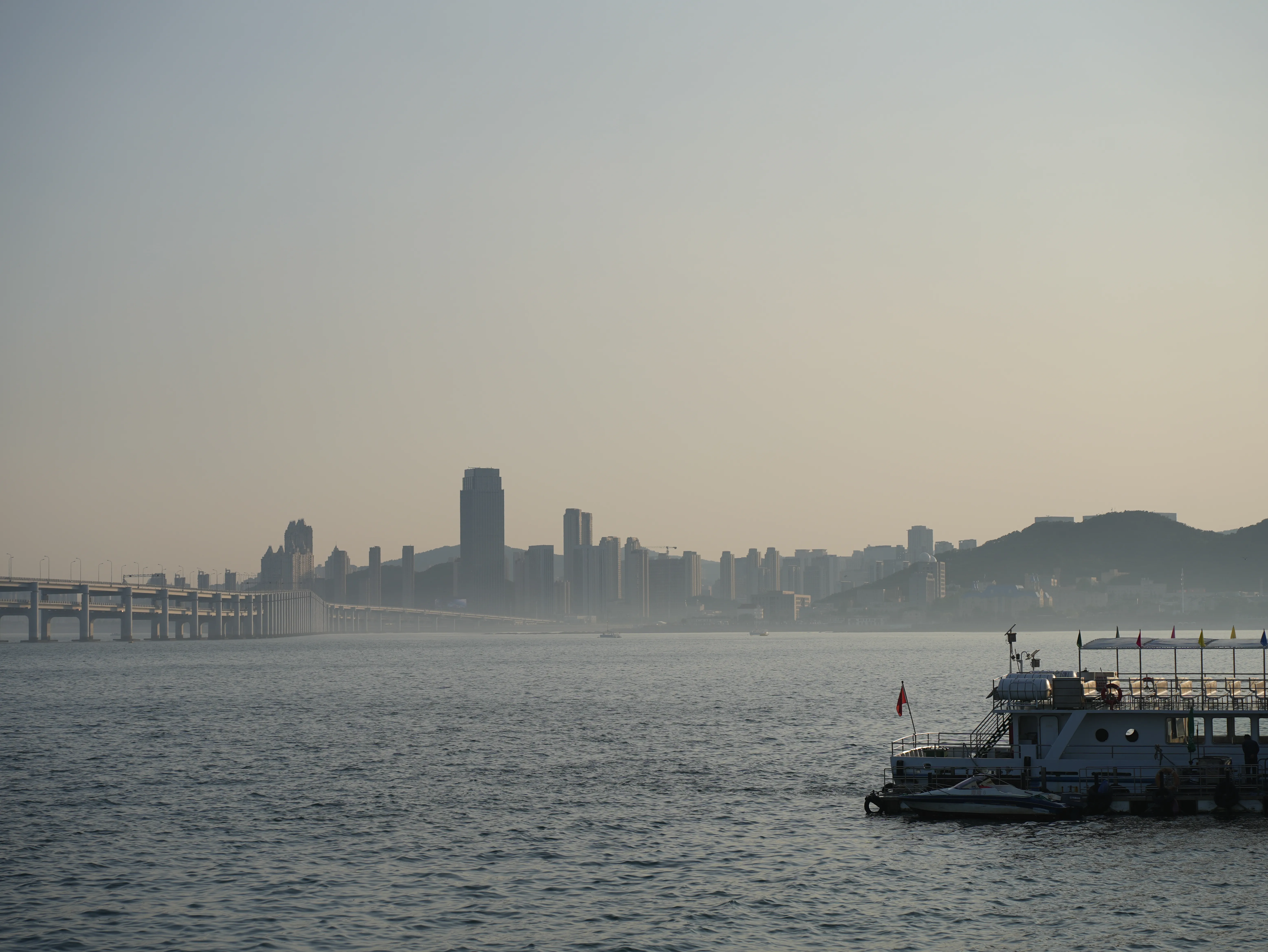View of the Xinghai Bay, including the Xinghai Bay Bridge and buildings in the background